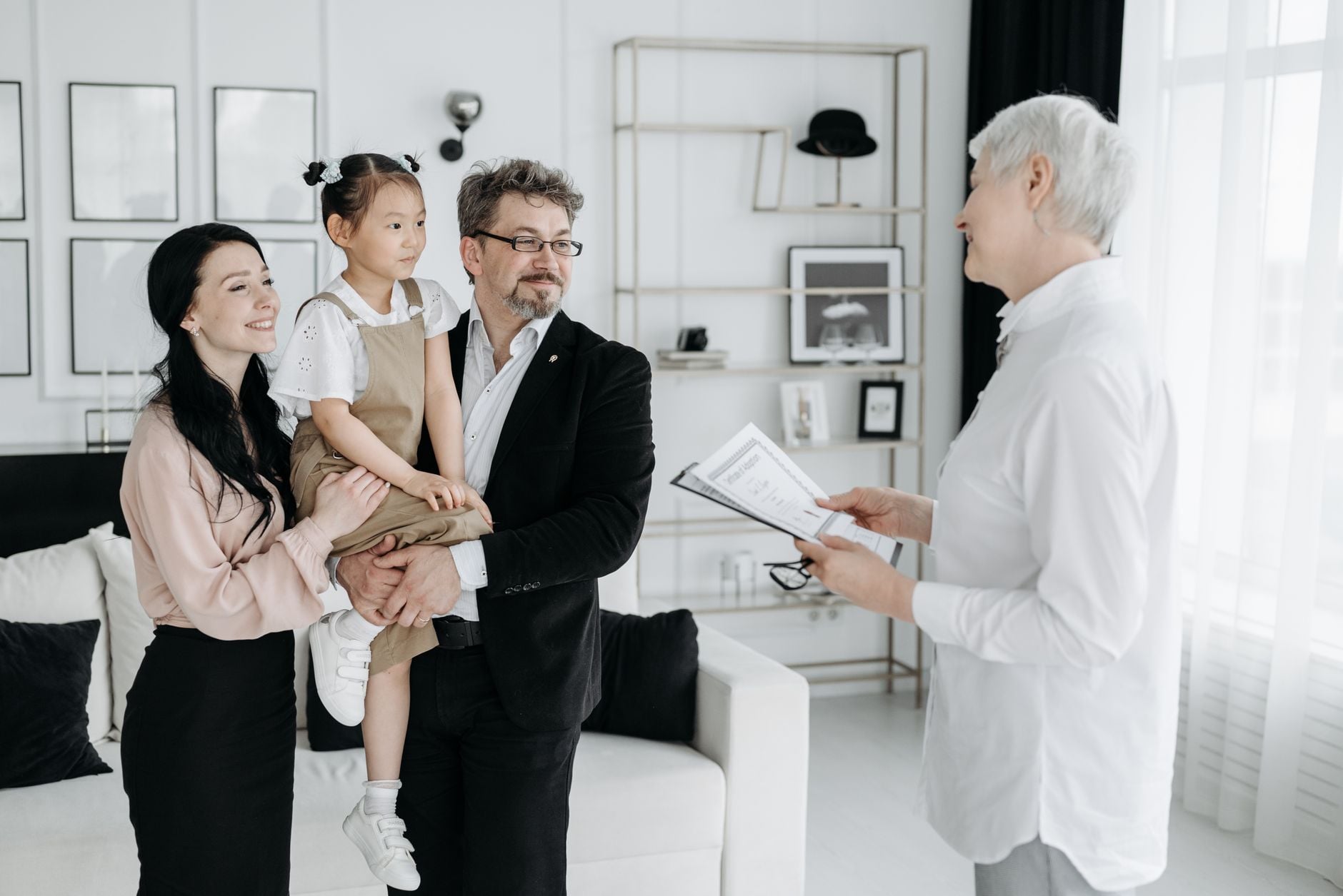 A joyful adoptive family meeting with a social worker indoors.