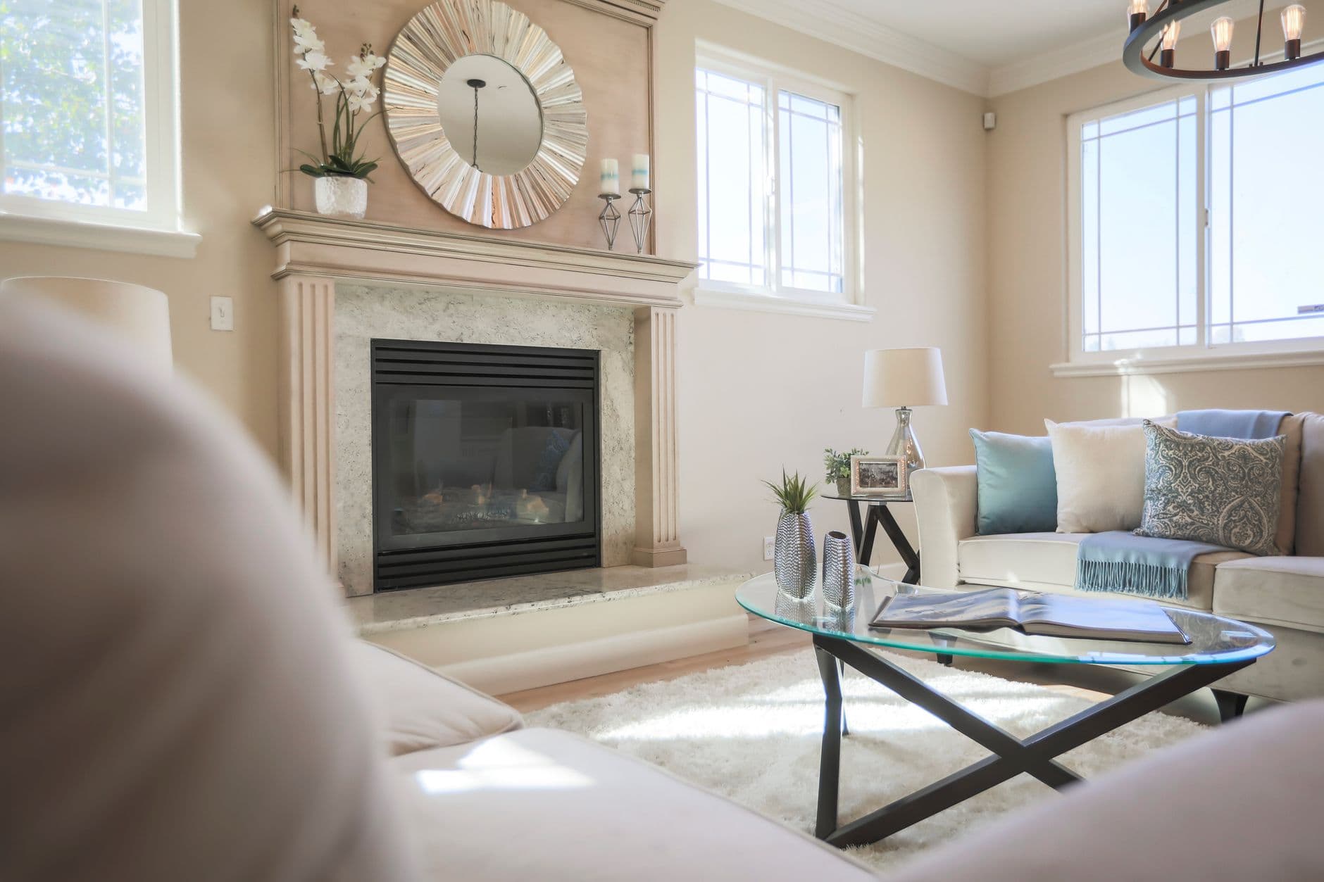 Bright and elegant living room featuring modern furniture and a stylish fireplace.